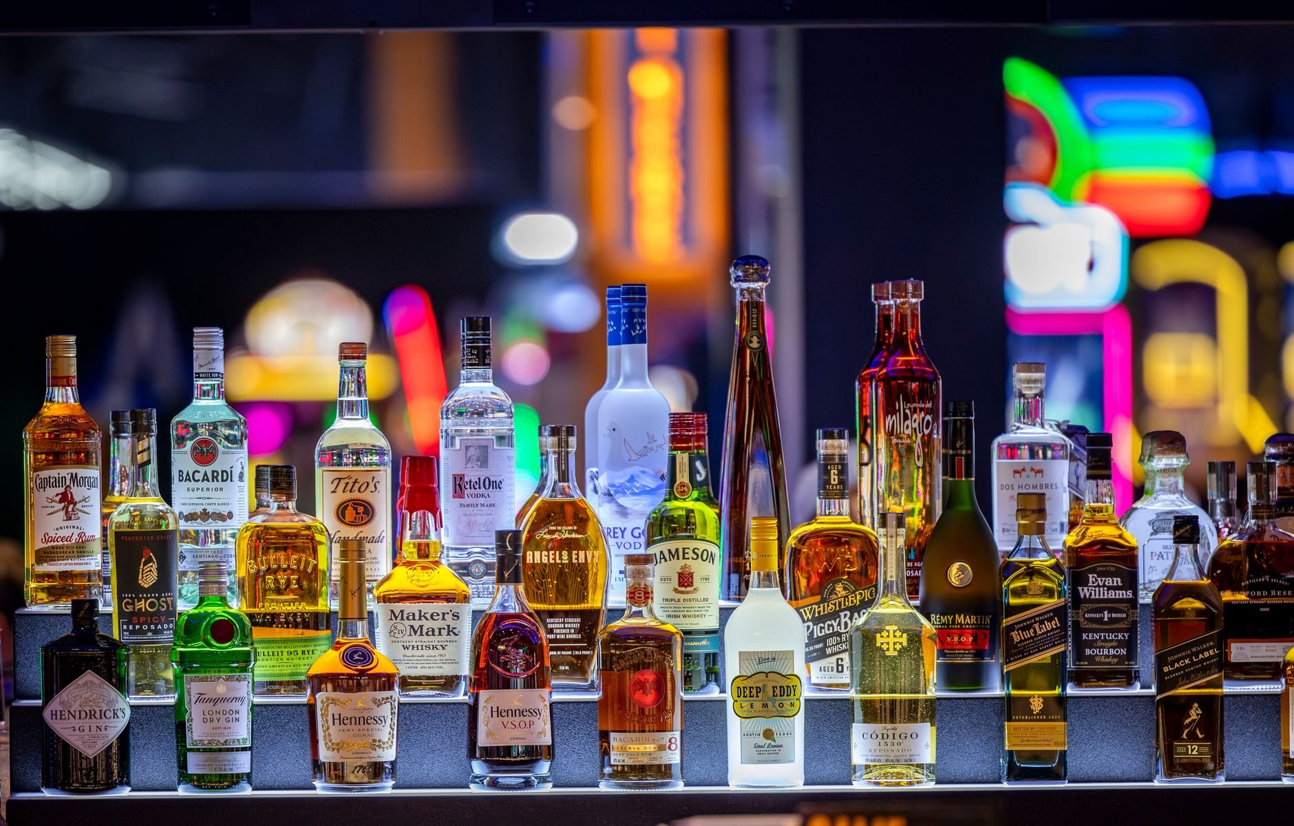 A vibrant selection of liquor bottles on display, creating a colorful and inviting bar atmosphere.